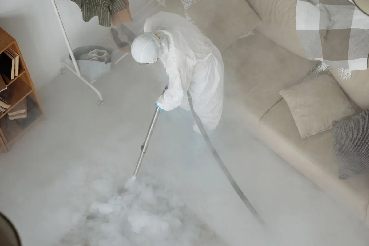 Biohazard cleanup technician in protective equipment, Scissors, TX